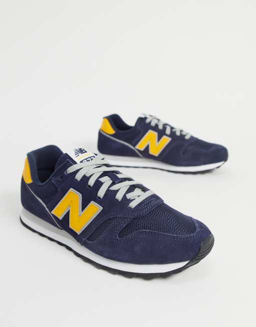 New Balance 373 sneakers in navy and yellow