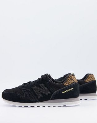 New Balance 373 trainers in black and 