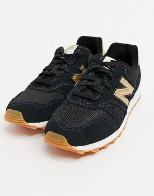 new balance 373 trainers in black and gold