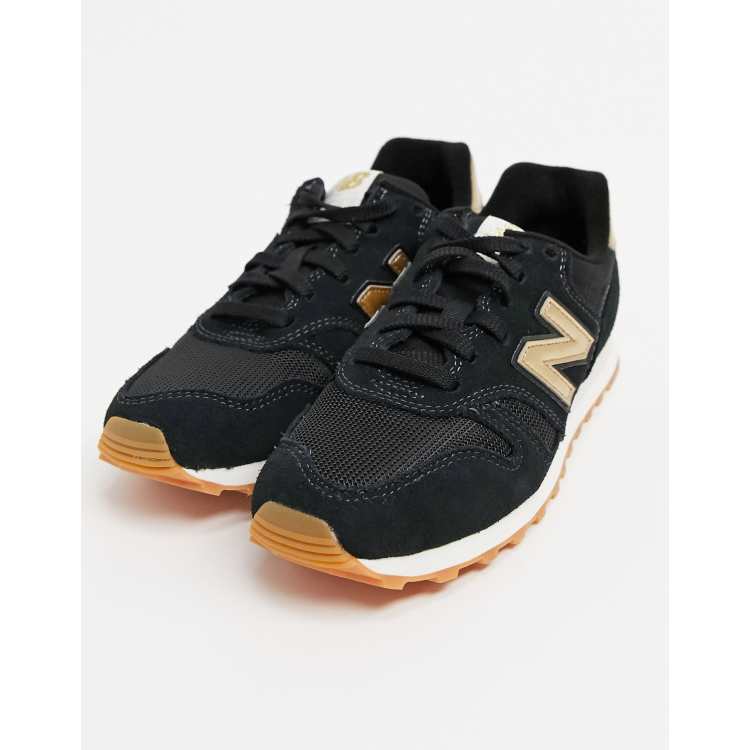 New balance black store and gold shoes