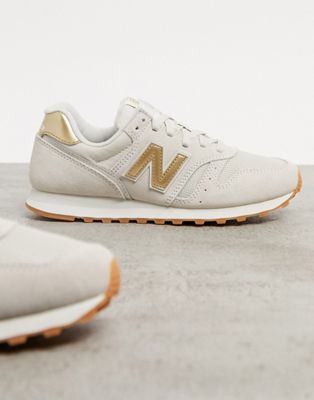 New Balance 373 trainers in cream and 