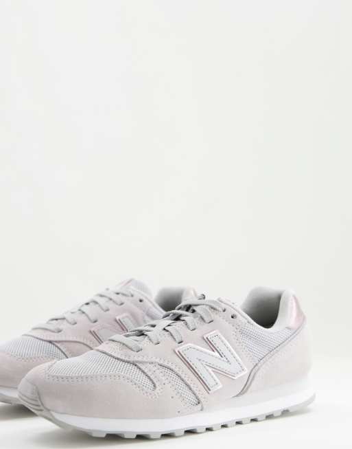 New Balance 373 trainers in grey and pink