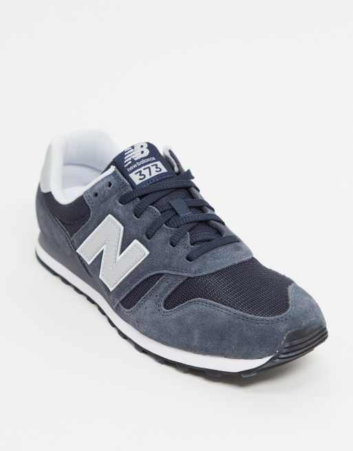 New Balance 373 trainers in navy and grey