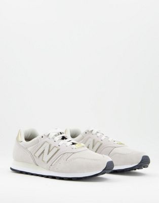 New Balance 373 trainers in oatmeal and gold
