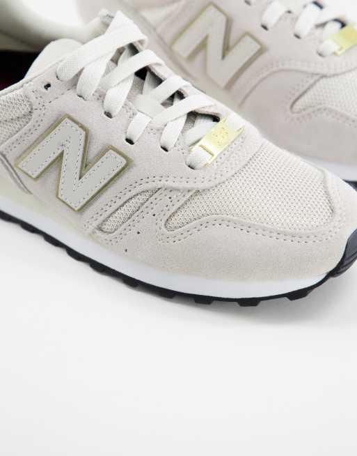 New Balance 373 trainers in oatmeal and gold