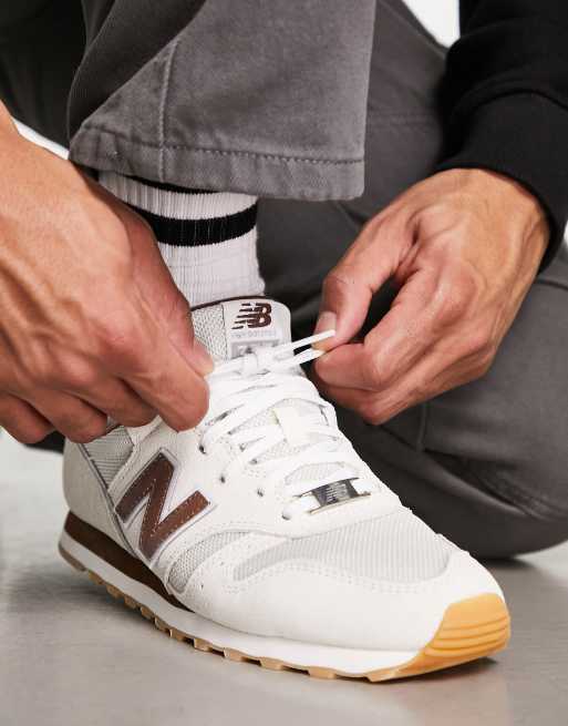 New Balance 373 trainers in off white and brown