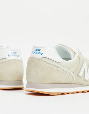 new balance 373 trainers in cream and gold