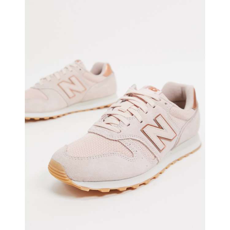 New Balance 373 trainers in pink and rose gold