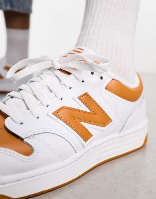 New Balance 480 trainers in white and orange