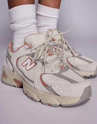 New Balance 530 sneakers in off white and red detail