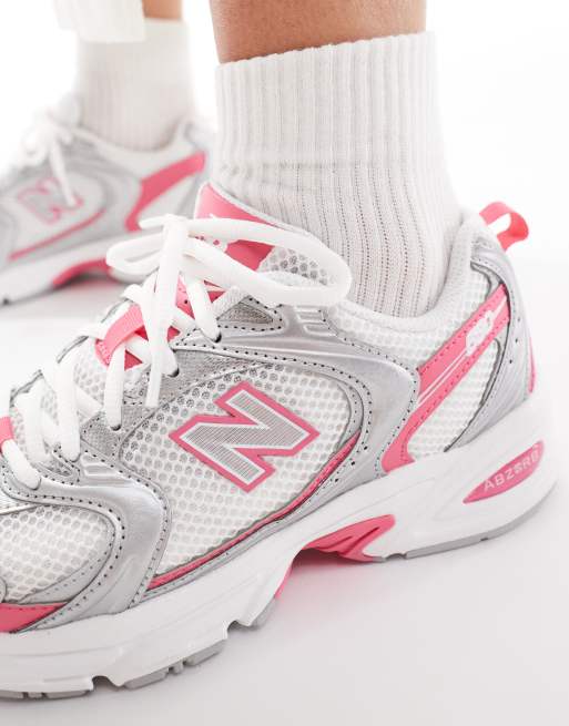 New Balance 530 sneakers in white and silver with pink detailing