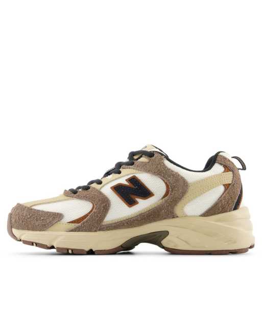 New Balance 530 sneakers in white with brown details