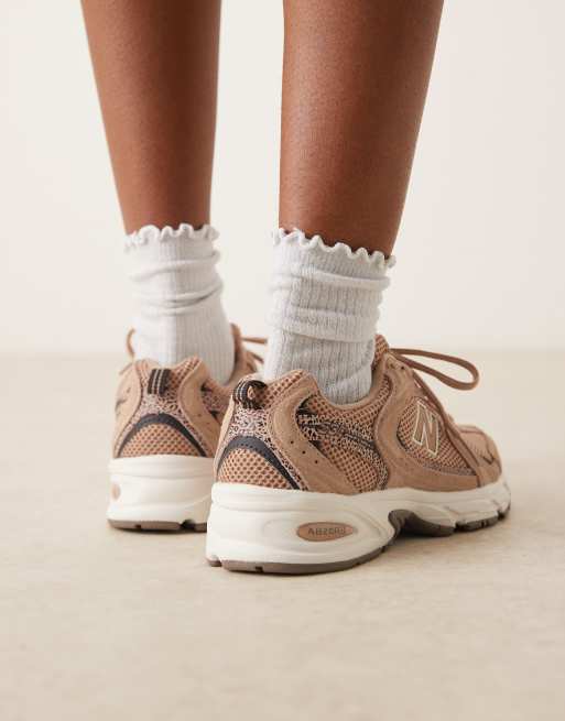 New Balance 530 trainers in light brown and leopard print