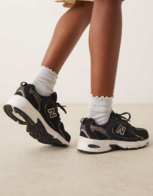 New Balance 530 trainers in black and leopard print