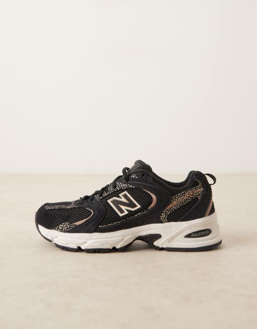 New Balance 530 trainers in black and leopard print