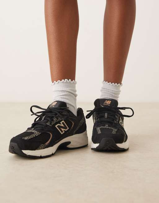 New Balance 530 trainers in black and leopard print