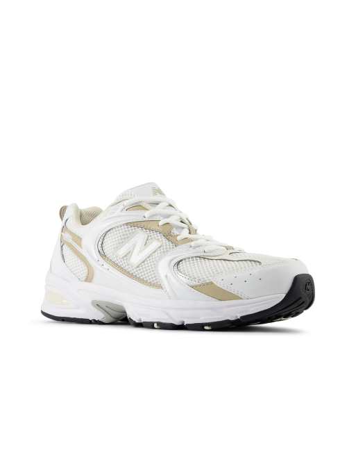 New Balance 530 trainers in white and gold