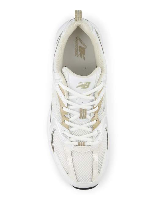 New Balance 530 trainers in white and gold