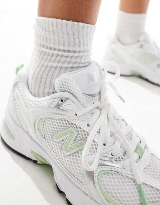 New Balance 530 trainers in white and pastel green exclusive to ASOS