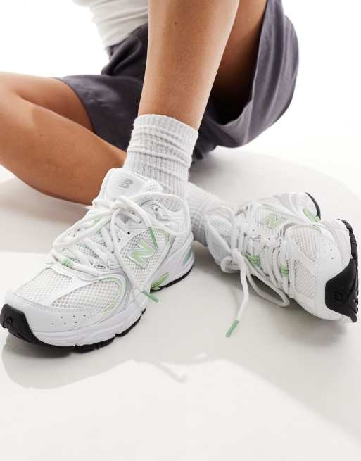 New Balance 530 trainers in white and pastel green exclusive to ASOS