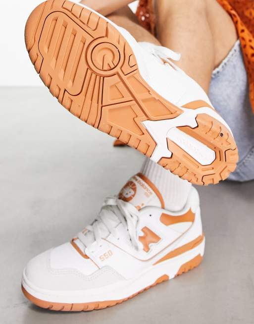 New Balance 550 sneakers in white and orange