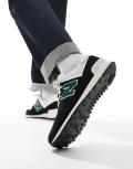 New Balance 574 sneakers in black and green