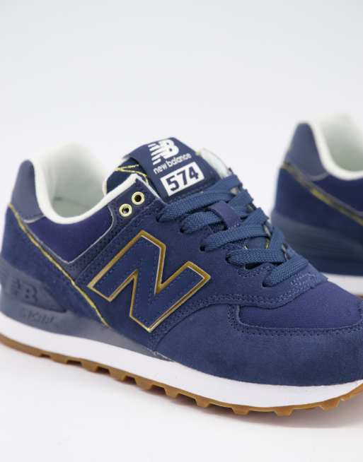 New Balance 574 Sneakers in marineblauw met gouden biezen