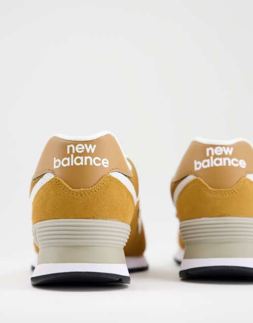 New Balance 574 sneakers in mustard yellow and white