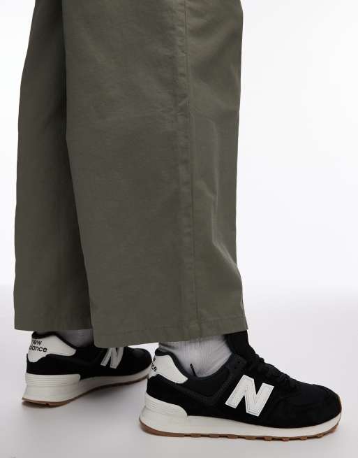New Balance 574 trainers in black and white, 4 of 5