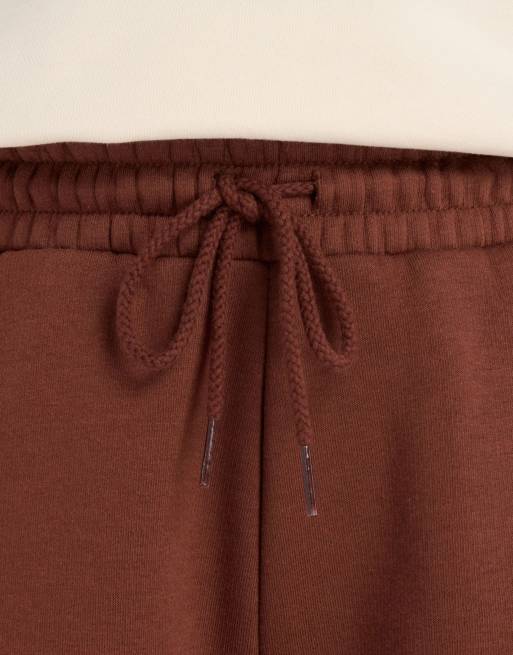 New Balance - Heritage - Pantaloni a fondo ampio in pile marrone con grafica lineare