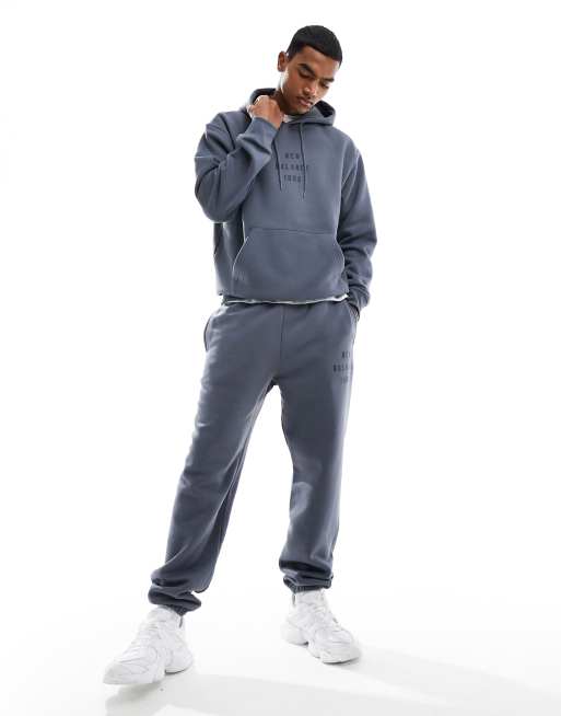 New Balance ICONIC COLLEGIATE JOGGER - Tracksuit bottoms - graphite/dark  blue - Zalando.de