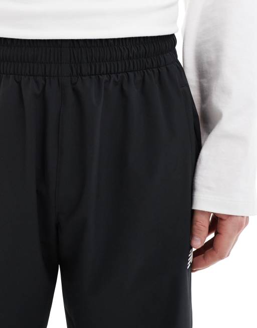 New Balance In game woven track pant in black