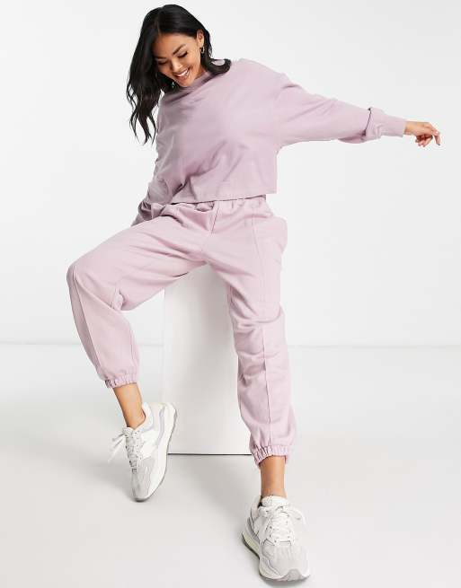 New Balance - Joggingbroek met logo in lila wassing