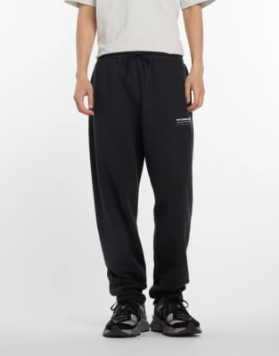 New Balance Linear graphic fleece pant in black