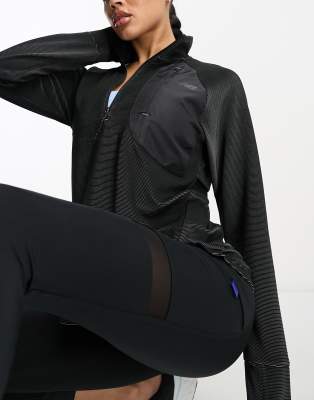 New Balance - Q Speed - Lagen-Oberteil in Schwarz mit halbem Reißverschluss