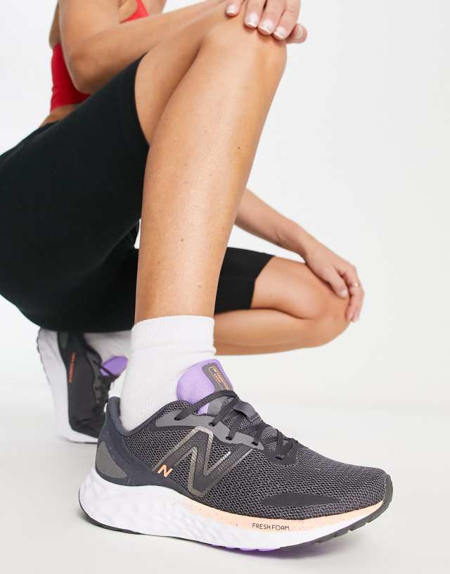 New Balance Running Arishi sneakers in black and purple