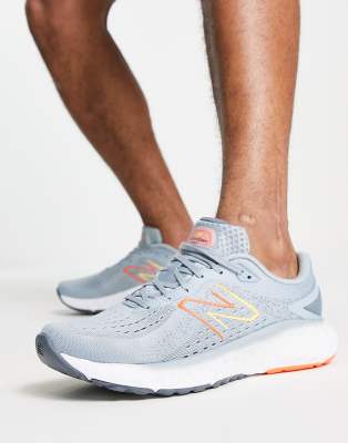 New Balance Running Evoz trainers in grey and orange