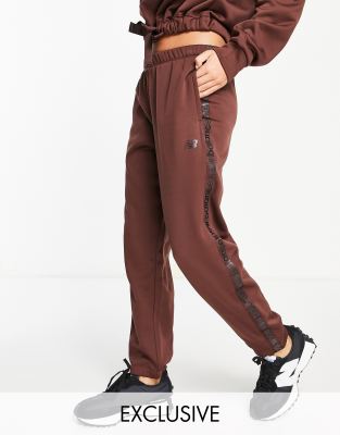 New Balance Running Joggers with logo taping in bitter chocolate exclusive to ASOS