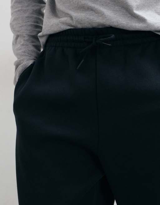 New Balance sport essentials fleece trackies in black, 3 of 5