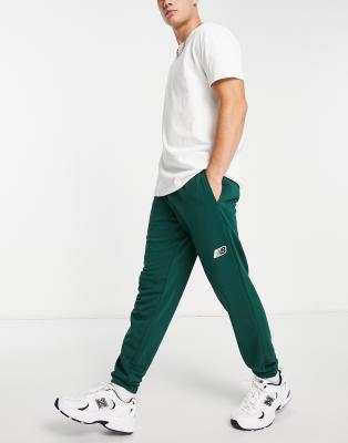 New Balance stacked logo trackies in green | ASOS