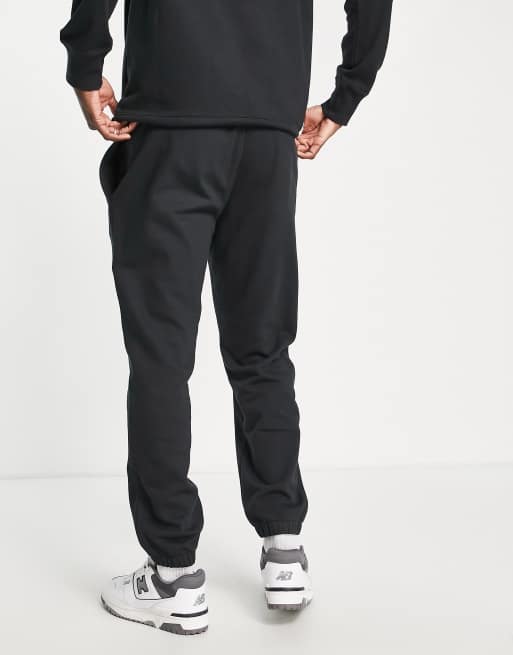 New Balance Running joggers with logo taping in black, ASOS