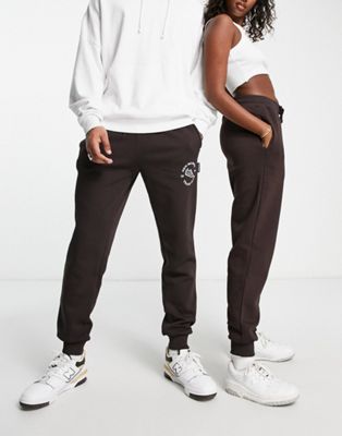 New Balance Unisex runners club joggers in dark brown - Exclusive to ASOS