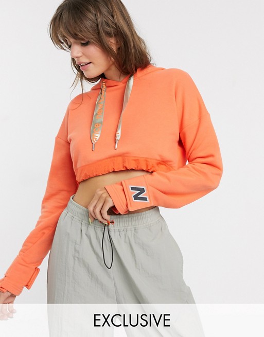 New Balance Utility Pack cropped hoodie in orange exclusive at ASOS