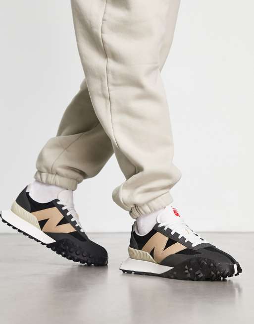 New Balance XC72 trainers in black and tan