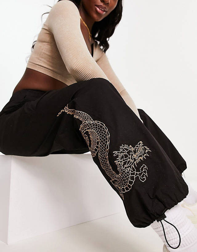 New Look - embroidered dragon parachute trousers in black
