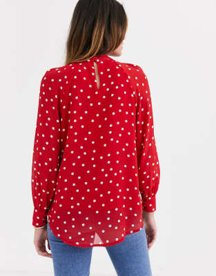 Red blouse with store white polka dots