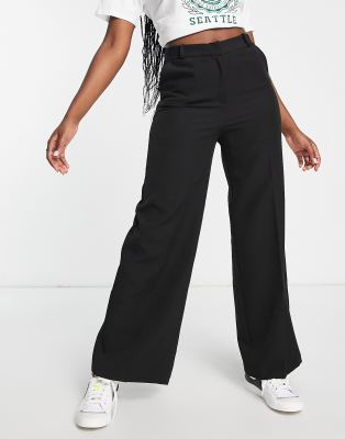 Bershka Petite folded waistband flared trousers in black