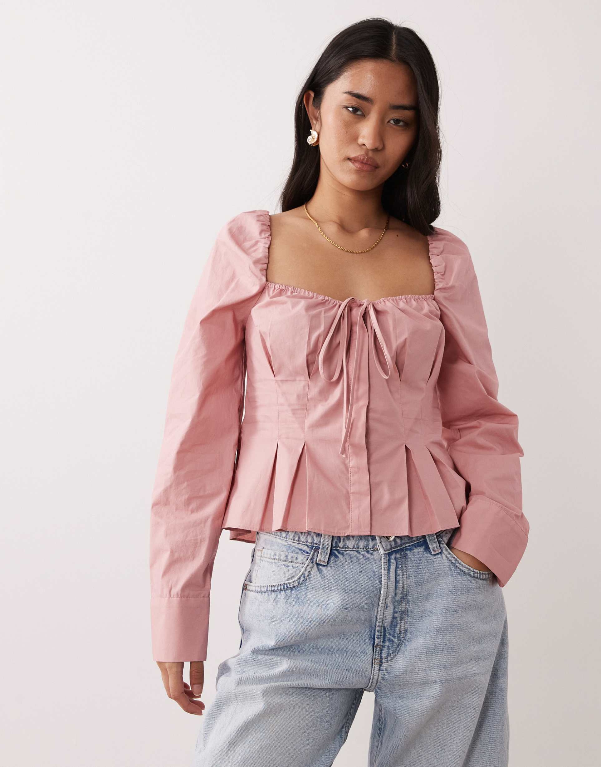 nia cloverfield long sleeve off the shoulder top in pink