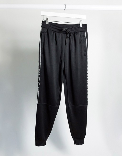 Nicce Vertex polytricot track joggers co-ord with panel logo in black