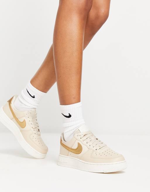 Nike AF1 07 trainers in pink and gold metallic